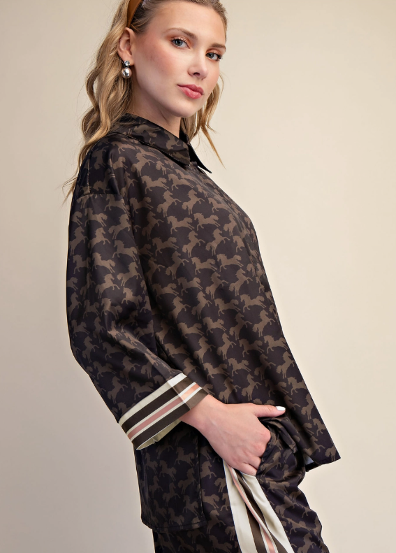 Woman wearing a patterned outfit with a neutral background