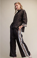 Woman wearing a satin western horse print top and pant