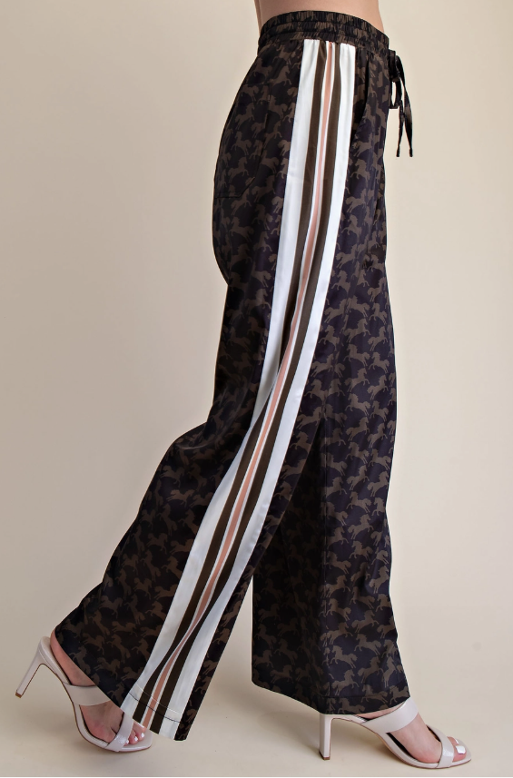 Woman wearing a satin western horse print top and pant