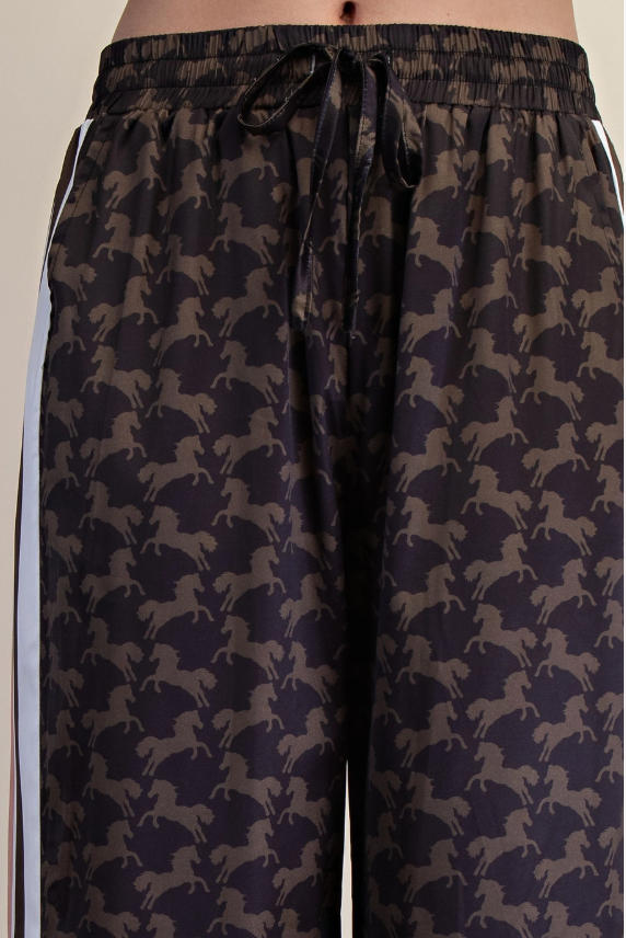 Woman wearing a satin western horse print top and pant
