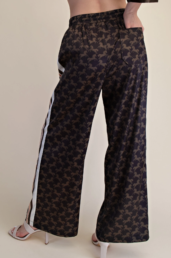 Woman wearing a satin western horse print top and pant