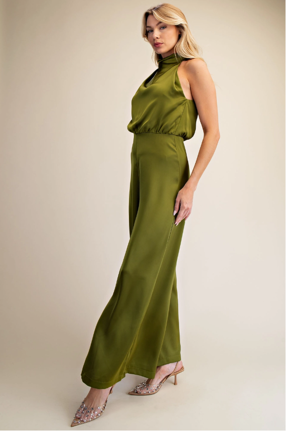 Woman wearing a green dress against a beige background